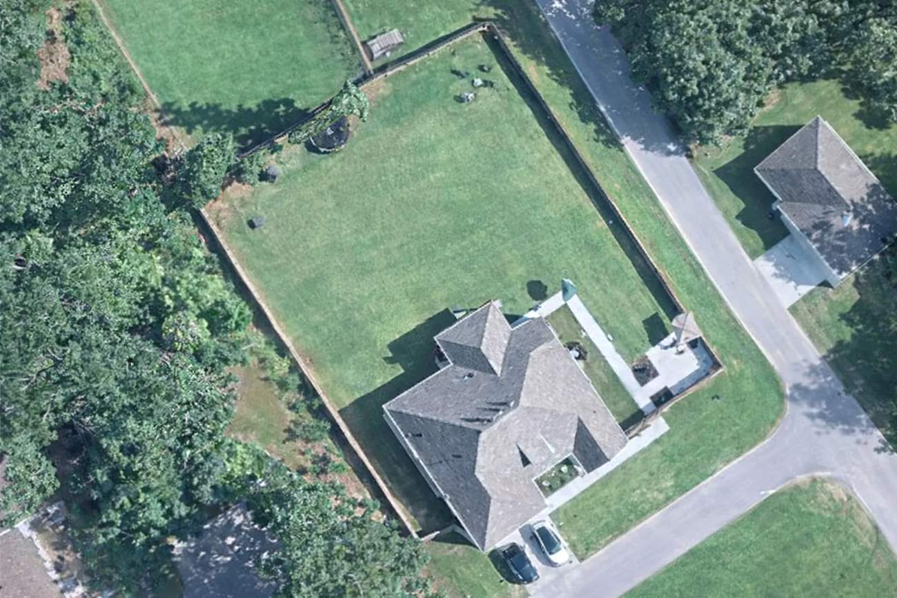 Aerial view of the property and fenced yard
